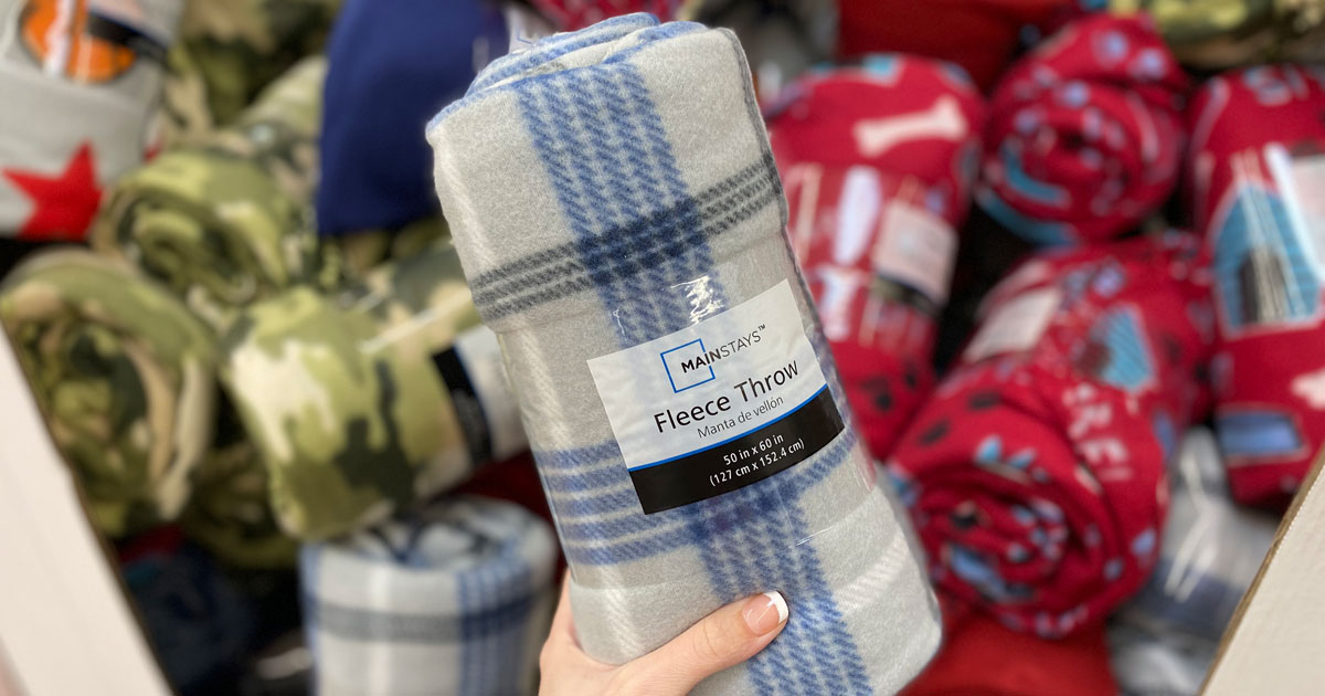 mainstays fleece throws hand holding a plaid one