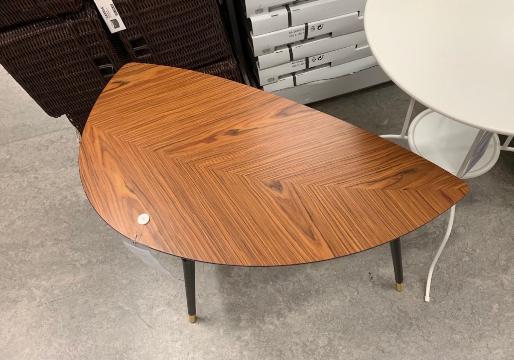 leaf shaped end table with brown and black wood grain 