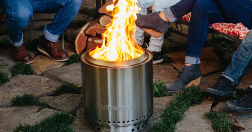 Family sitting around Solo Campire Stove