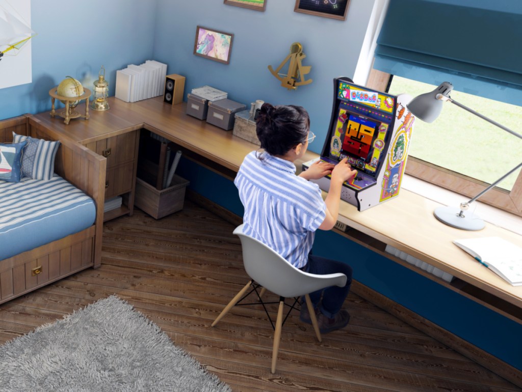 girl playing space invaders counter arcade machine
