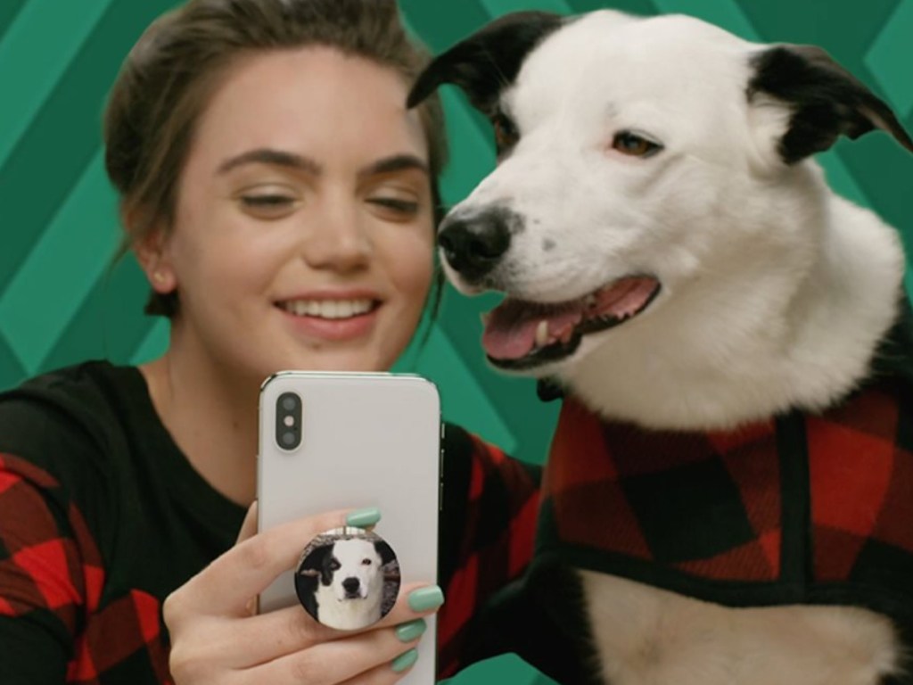 Girl sitting with dog and custom popsocket