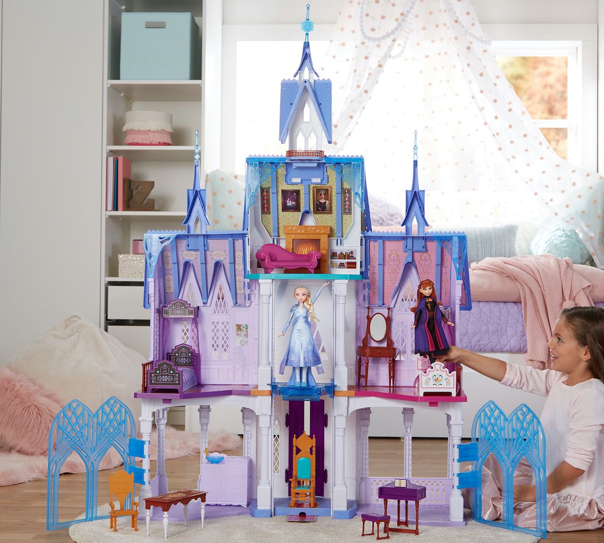 girl playing with Disney Frozen Ultimate Arendelle Castle in bedroom