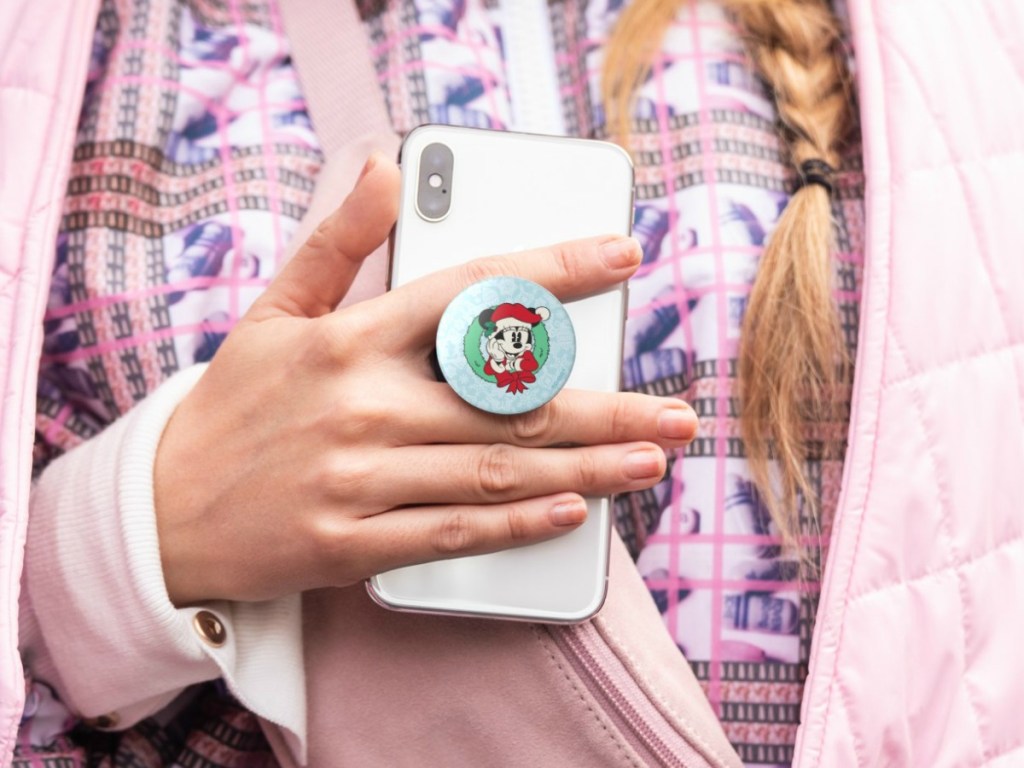 Girl holding phone with Disney Minnie Christmas PopGrip