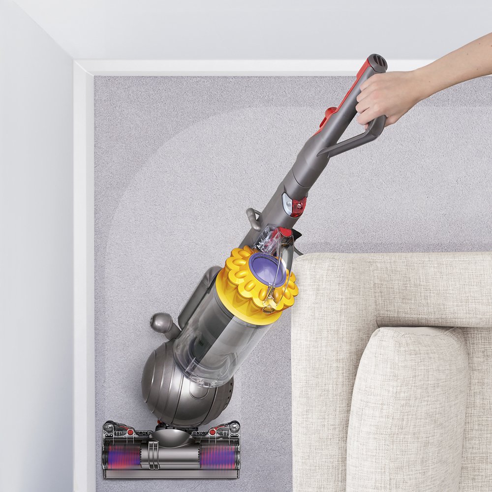 woman vacuuming with dyson vacuum