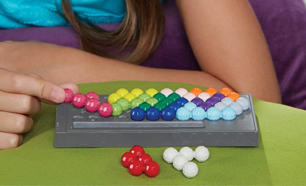 kid playing with kanoodle game