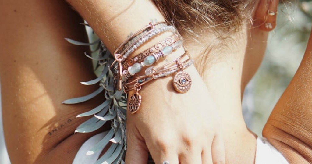 Alex and Ani Charm Bangles on a ladies arm