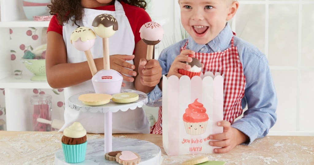 boy and girl playing with Fisher-Price Cakepop Stand
