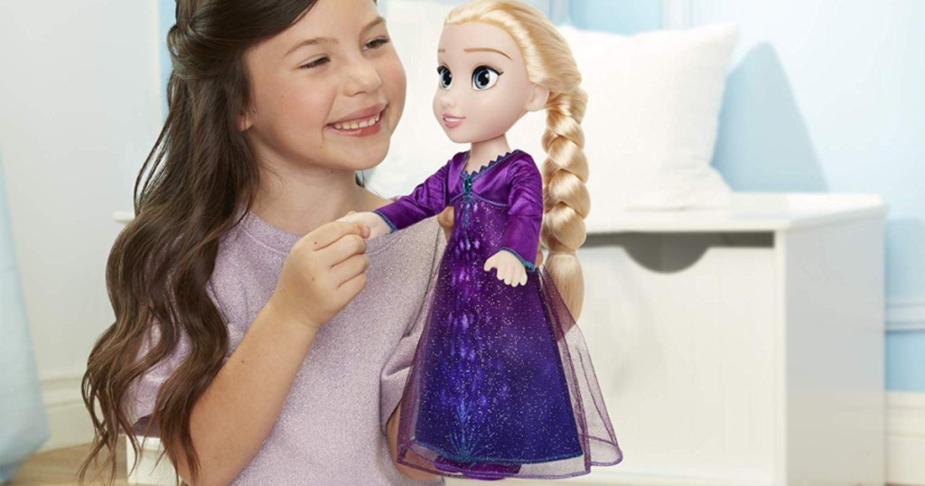 girl playing with frozen 2 elsa doll