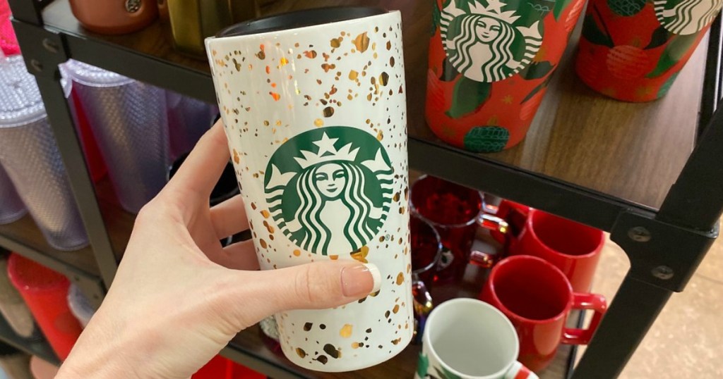 woman holding Starbucks white Insulated Travel Mug with gold flecks and a black lid