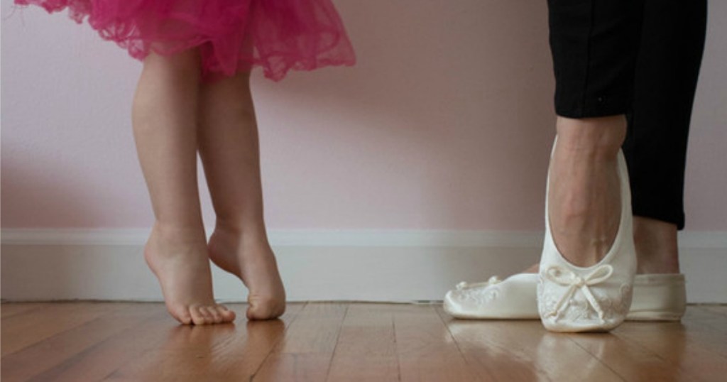 woman wearing Isotoner slippers next to toddler