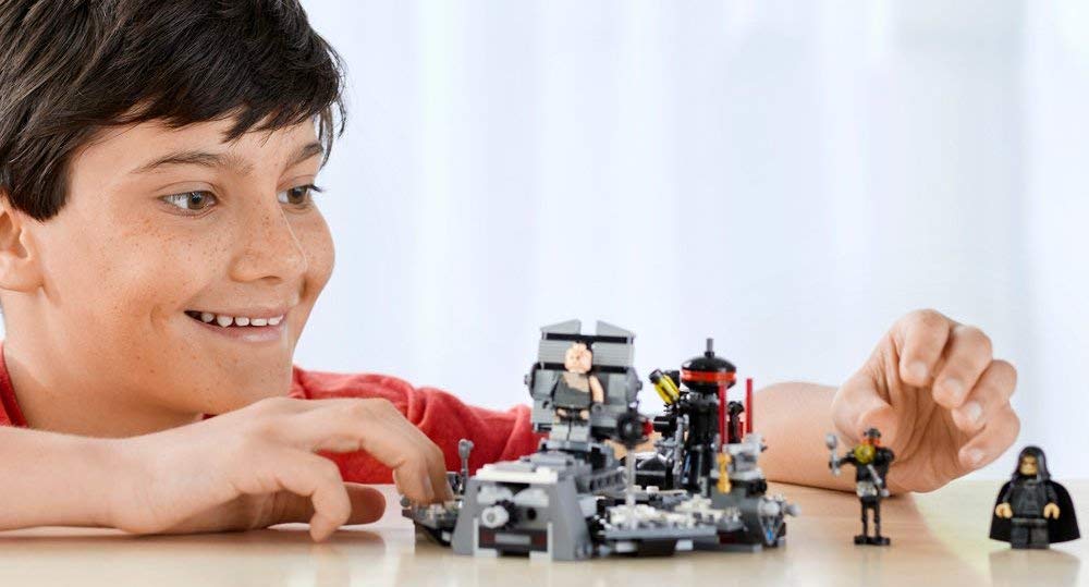 boy playing with LEGO Star Wars Darth Vader Transformation