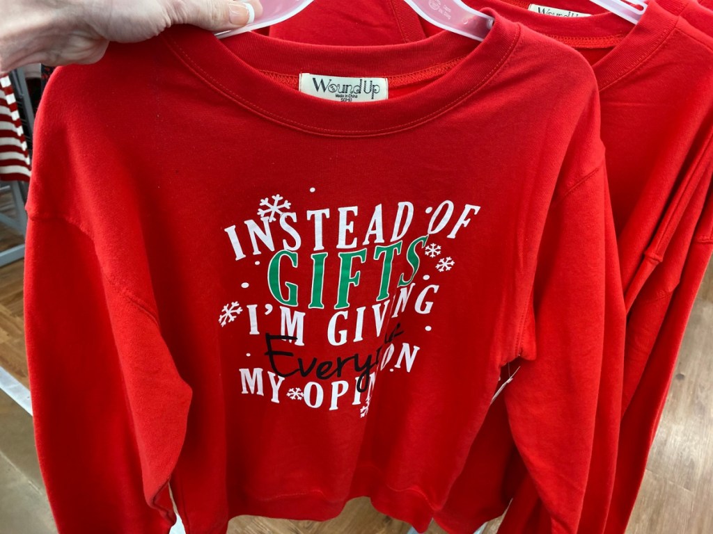 hand holding red holiday sweatshirt