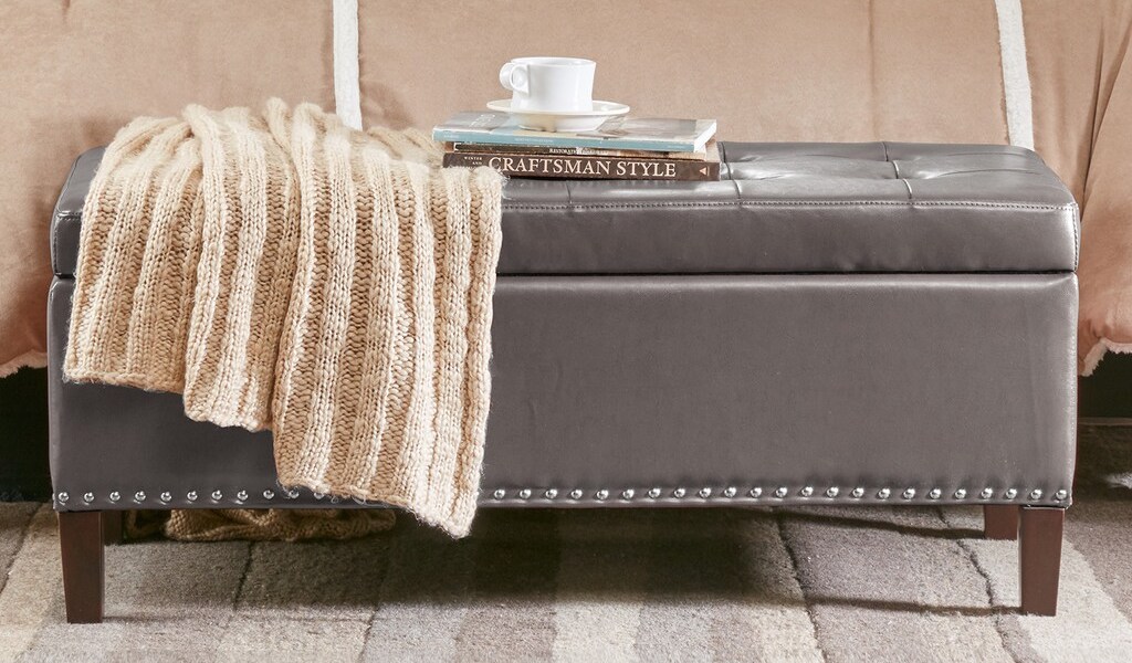 Madison Park Ottoman with blanket and books