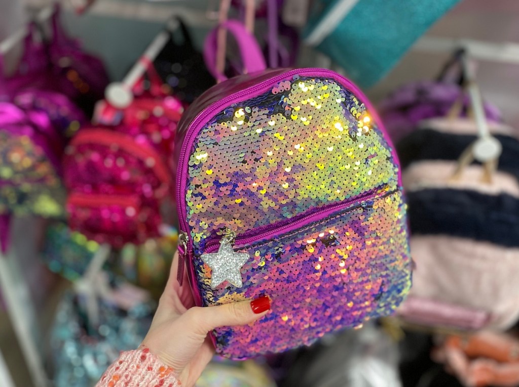 hand holding More Than Magic Sequin Backpack