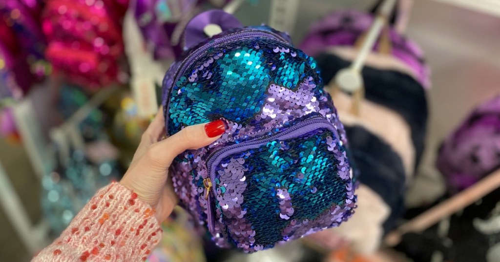 hand holding More than Magic Sequin Backpack