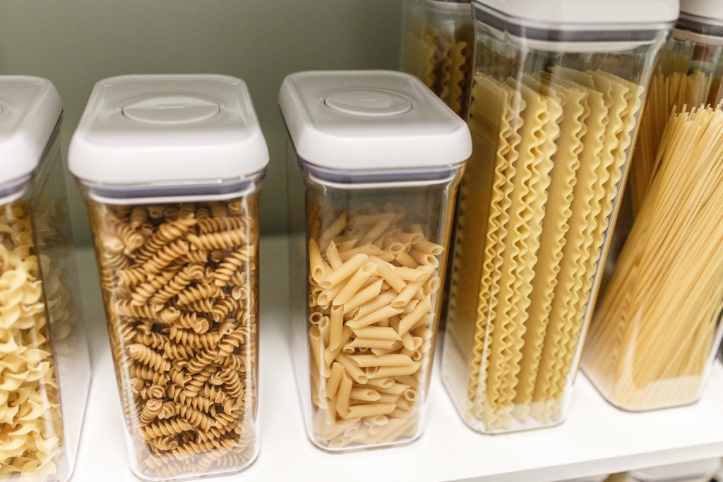row of pastas inside clear food storage containers