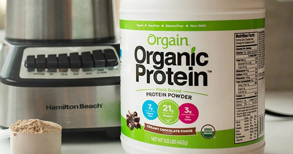 Orgain Organic Protein Powder container next to mixer