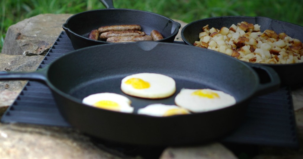 Ozark Cast Iron Skillet three pack with breakfast foods at camp