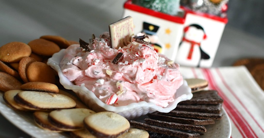 peppermint cheesecake dip in bowl on platter with cookies 