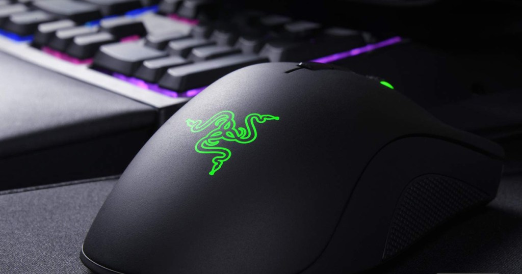 Razer DeathAdder Elite Gaming Mouse with lit up gaming keyboard in the background