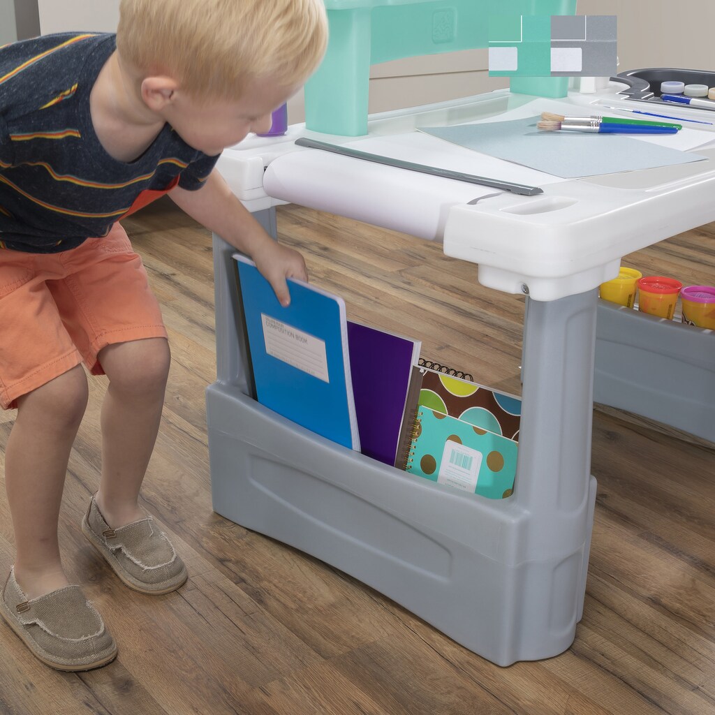 kid putting books in the Step2 Desk