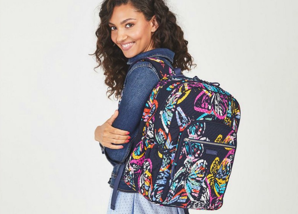 woman wearing multi-colored backpack