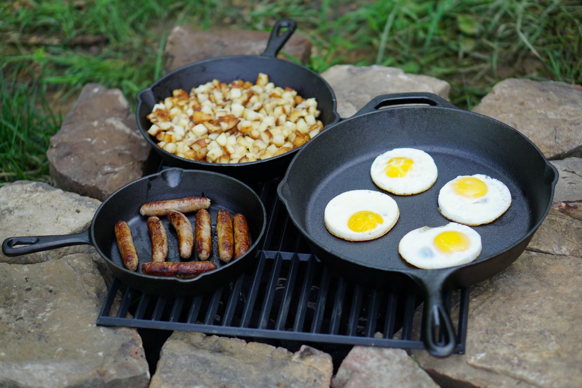 Three Ozark Cast Iron Skillet with breakfast foods at camp