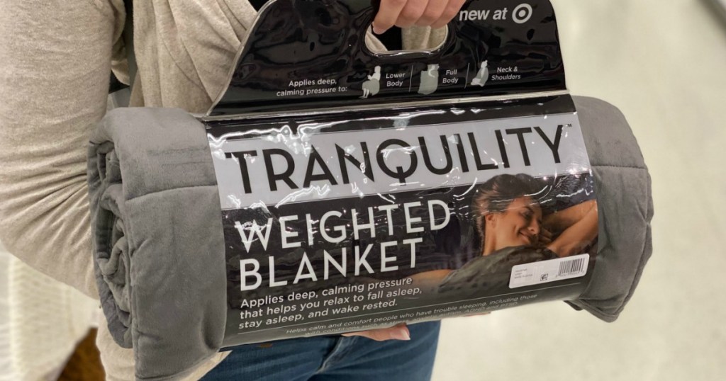 Woman holding a weighted blanket in the package