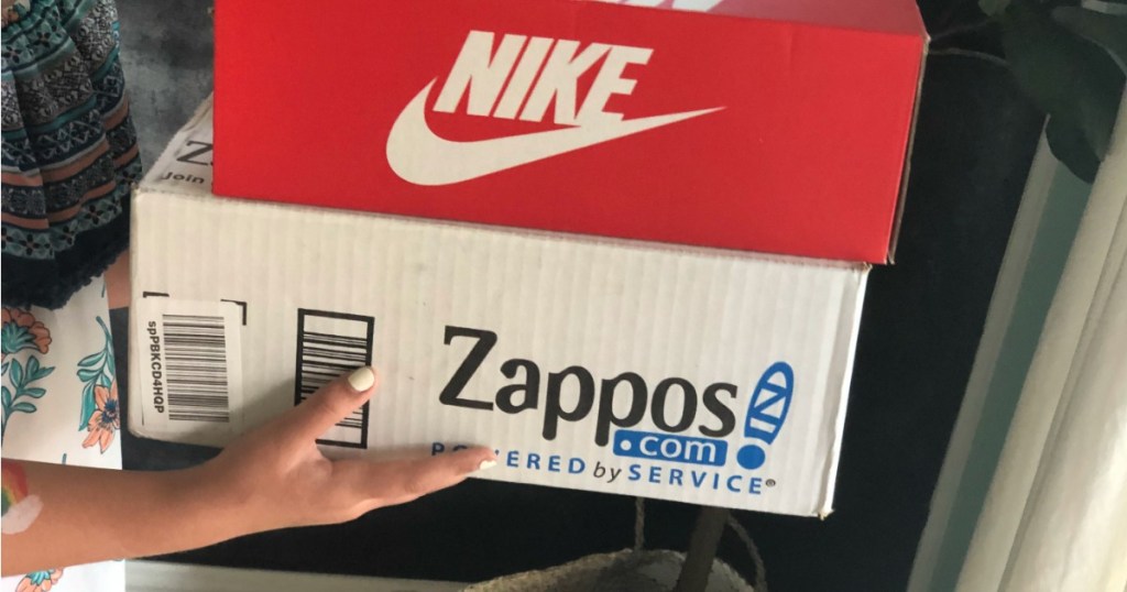 Woman holding Zappos.com box