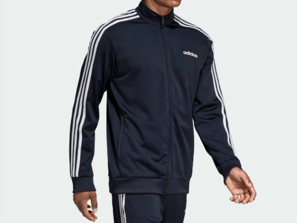 man walking wearing navy blue tracksuit