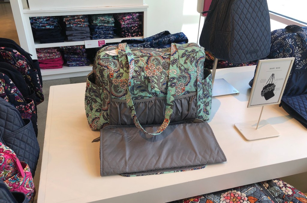 blue floral baby bag sitting on store display shelf