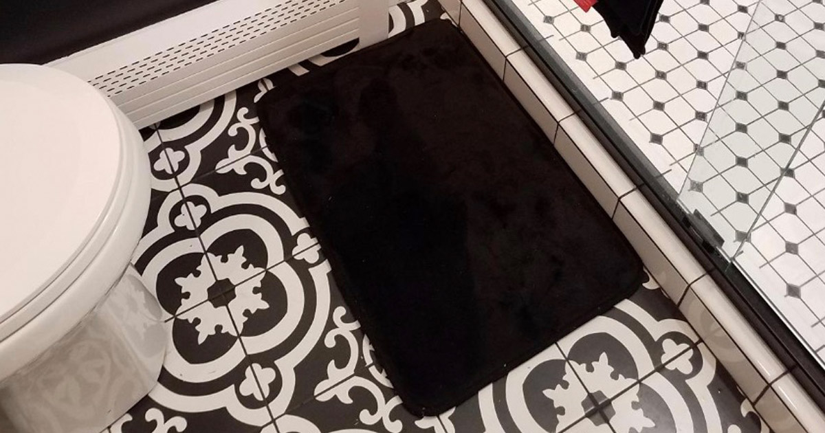 black bath mat outside of shower