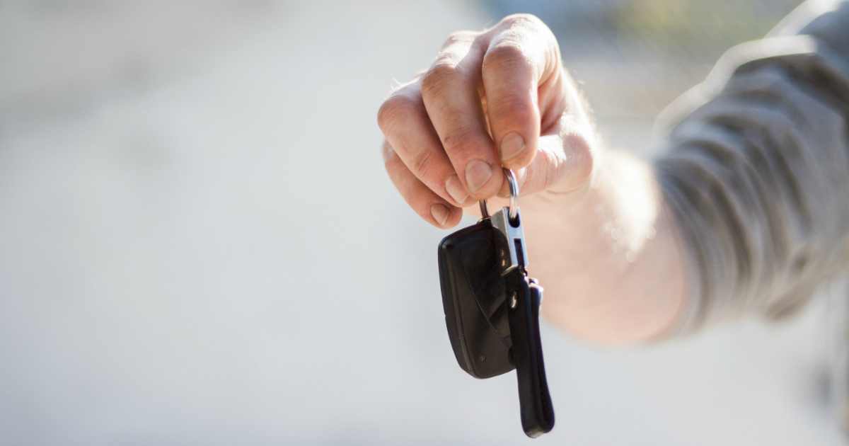 car rental person holding car keys
