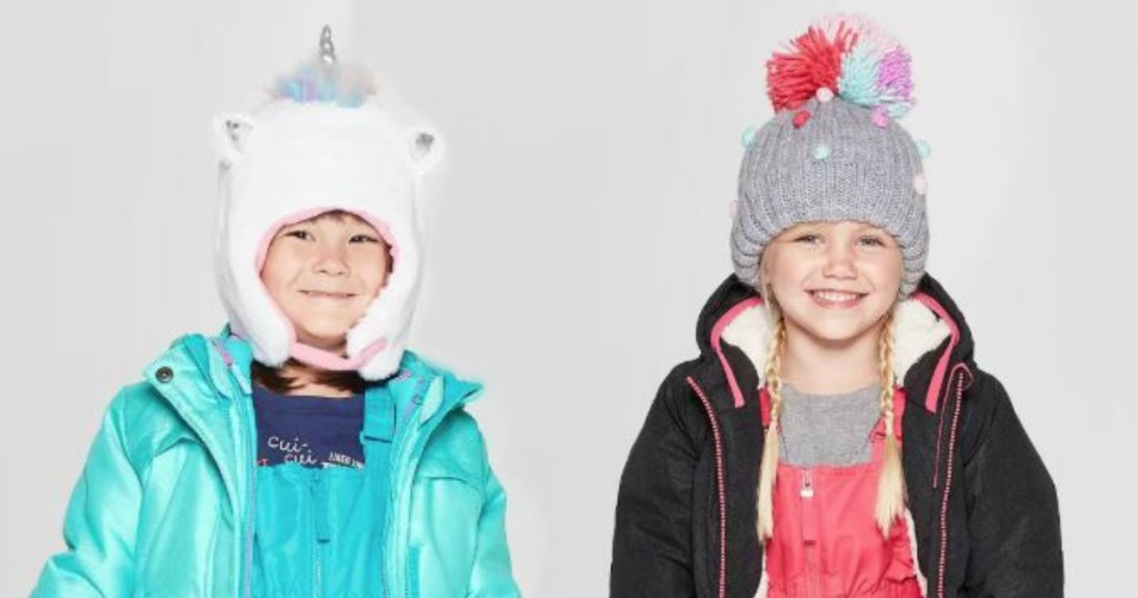 two little girls wearing snow hats and smiling