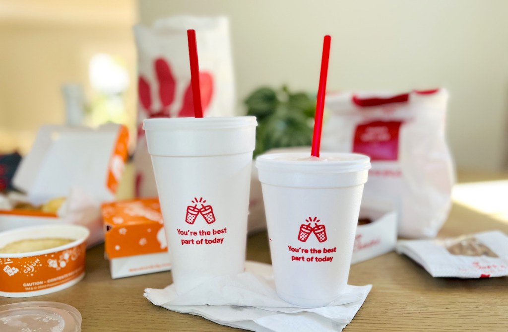 chick fil a cups on table with takeout foods