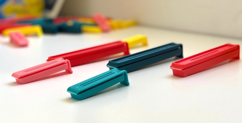 colorful yellow red and blue clips sitting on white counter