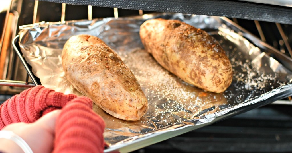 getting baked potatoes out of the oven