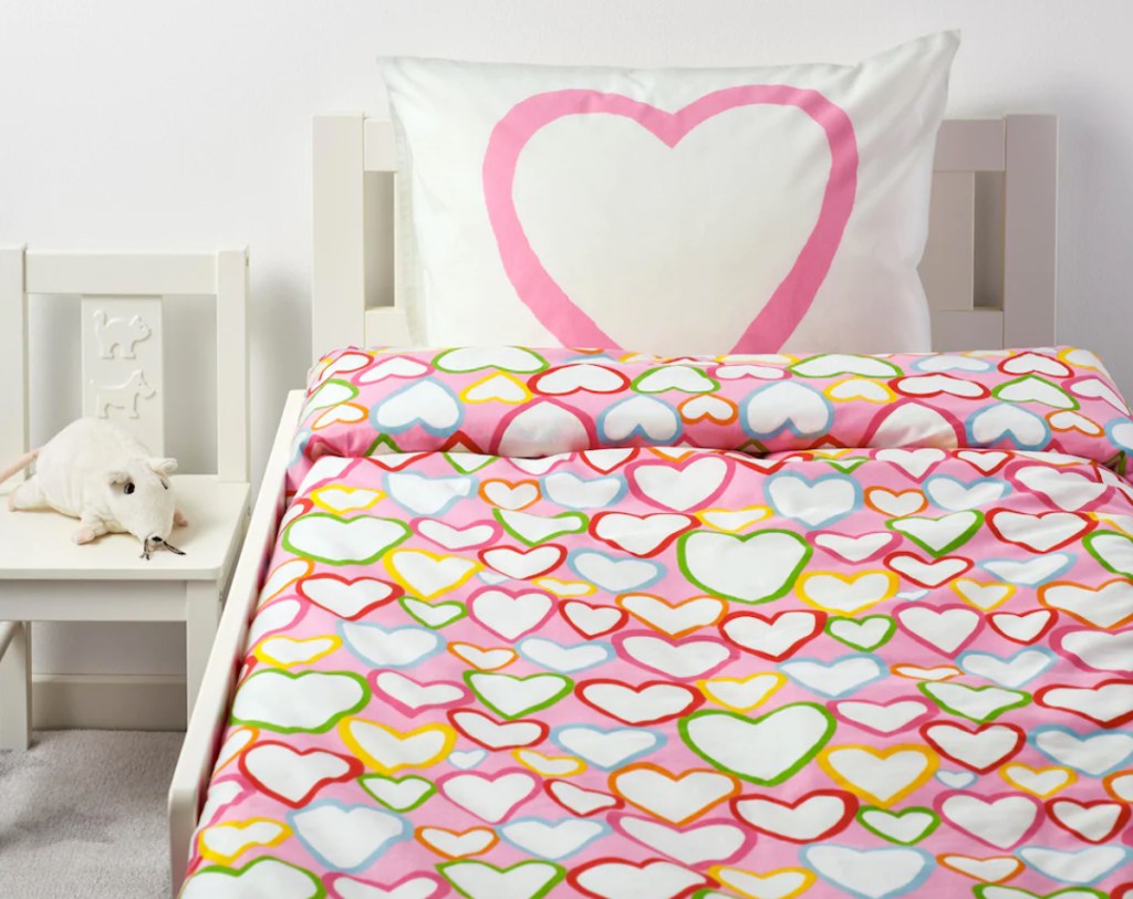 bedroom with pink heart bedding and pillow on bed