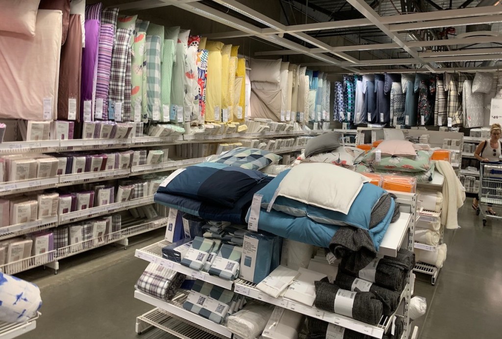 rows of various colored bedding hanging from store shelves