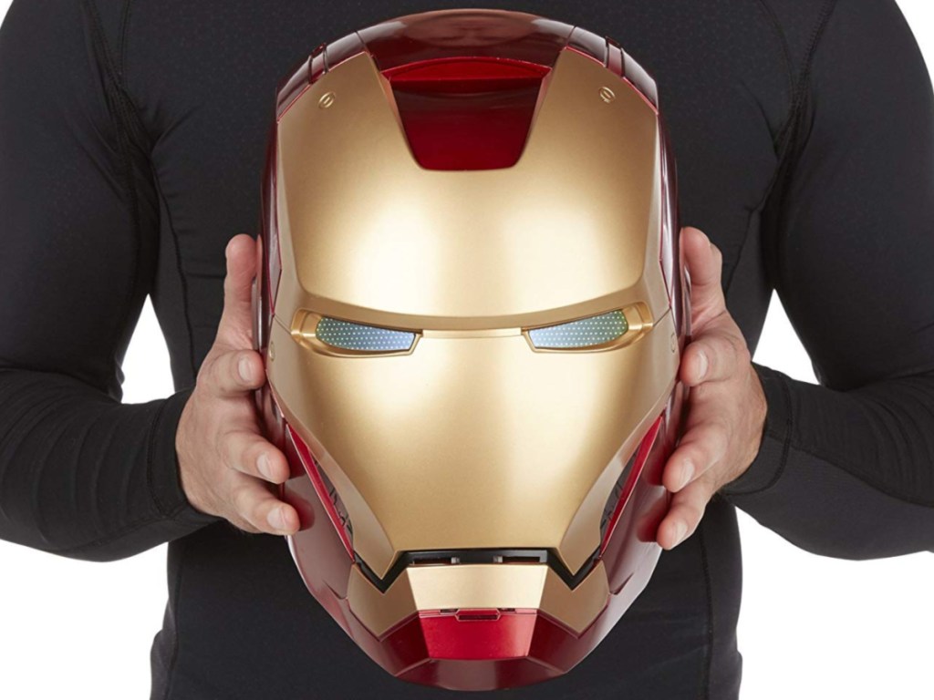 man holding iron man mask