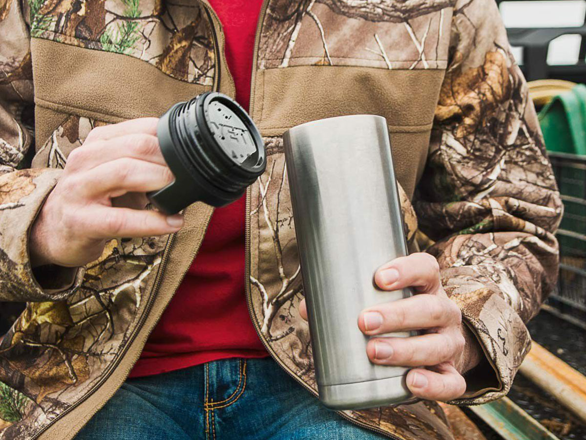 man opening a yeti water bottle