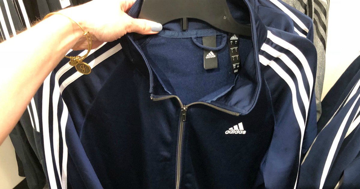 hand holding jacket on hanger in store