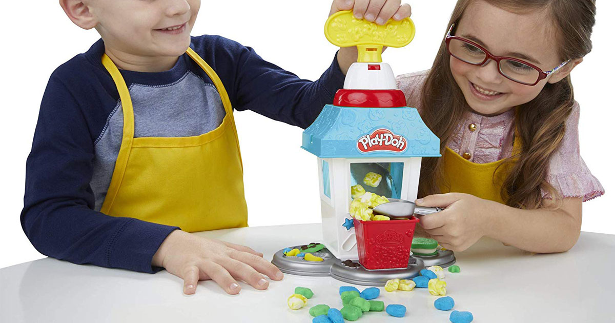 girl and boy playing with the Play-Doh Kitchen Creations Popcorn Party Play Food Set
