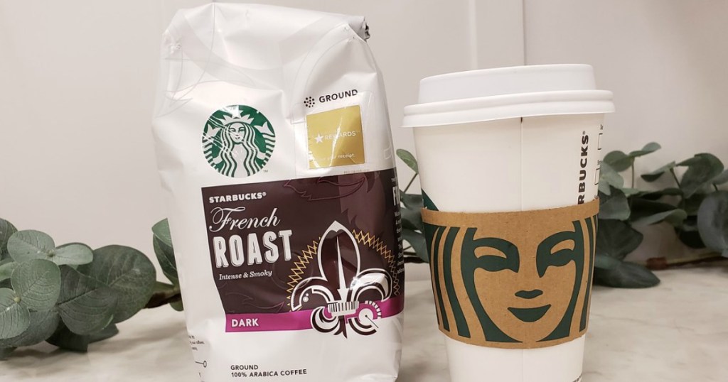 bag of coffee next to coffee cup on table