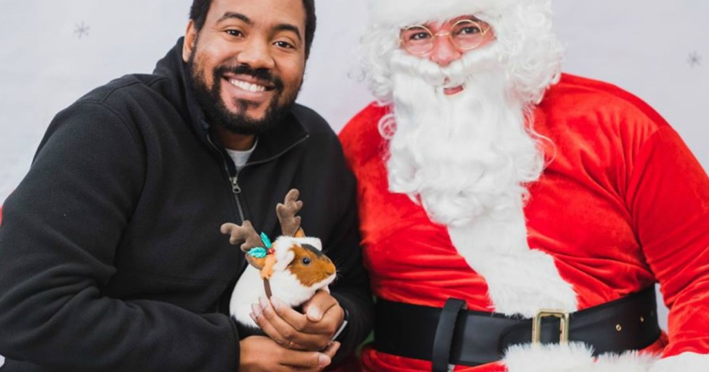 santa claus and man holding pet hamster