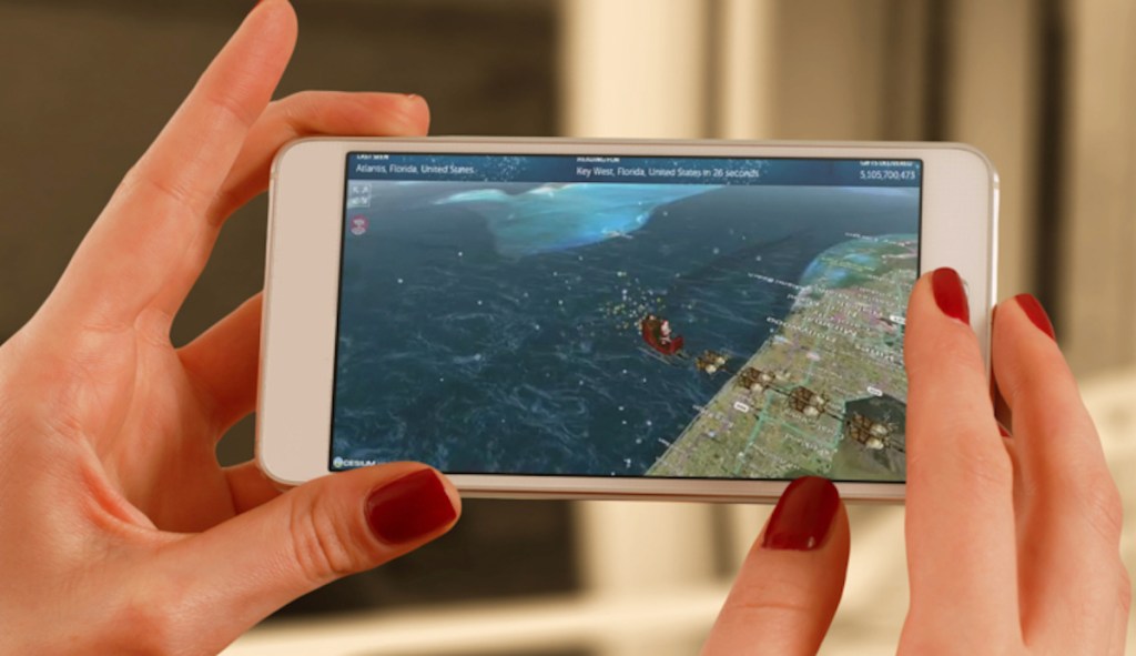 hands holding a phone with santa tracker on screen