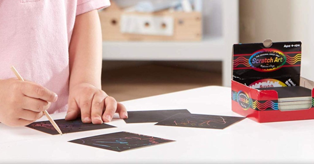 kid using scratch art