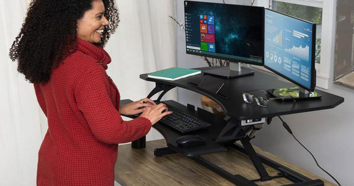 woman typing at 36" 2-Tier Electric Adjustable Dual-Monitor Standing Desk w/ Charging Port