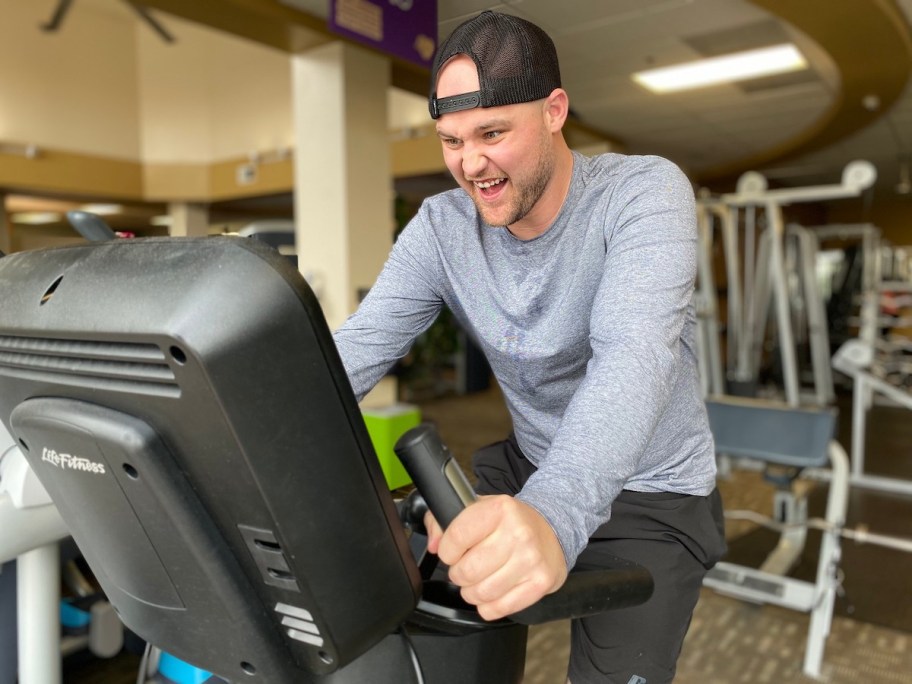 man on pedal bike machine in gym