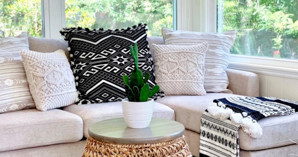 white and black throw pillows sitting on cream couch in sun room